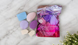 Sweet Beauty Power Pocket Puff dual sided powder puff pack of 7 makeup sponges in assorted shapes and colors on marble surface