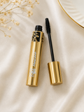 HSA luxury gold mascara tube open with black volumising wand applicator on cream satin fabric with dried flowers